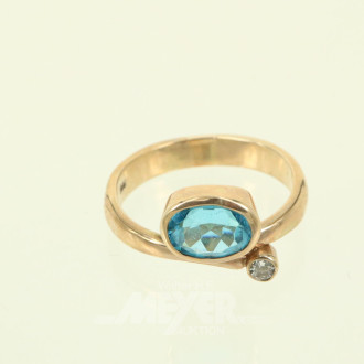 Damenring, besetzt mit 1 oval facettiertem Farbstein (Topas) sowie 1 kl. Diamant