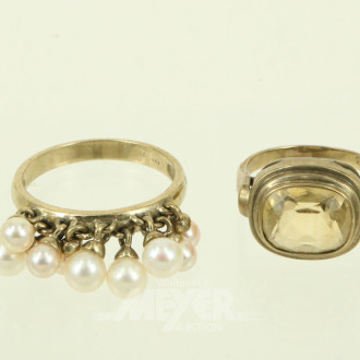 2 Ringe, davon 1 mit beweglichen Perlen u. 1 mit gelbem Farbstein