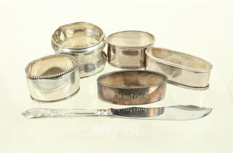 5 versch. Serviettenringe dt. Hersteller u. 1 engl. Buttermesser, 800er bis 925er Silber